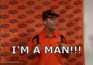 Man In Orange Shirt And Hat Saying I'm A Man GIF
