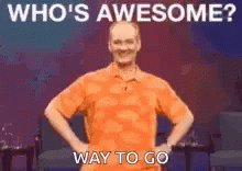Man in Orange Shirt Hands on Hips Says Who's Awesome Way to Go