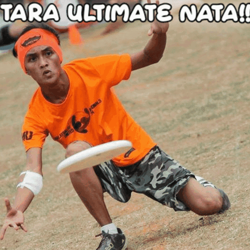 Man in Orange Shirt Holding Frisbee Saying Tara Ultimate Nata