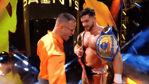 Man In Orange Shirt Next To Wrestler GIF