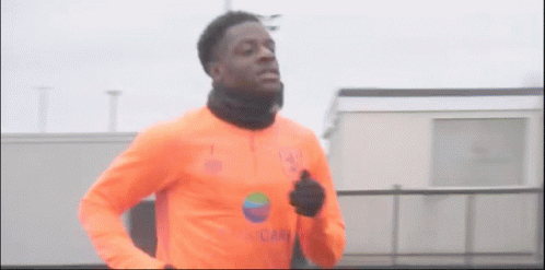 Man in Orange Shirt Running