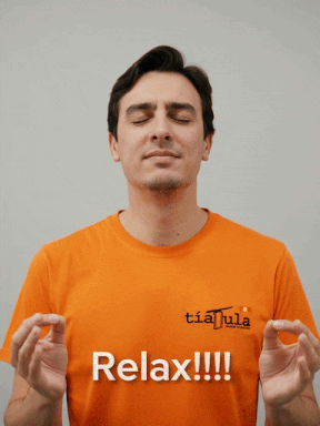 Man in Orange Shirt Saying Relax With Eyes Closed