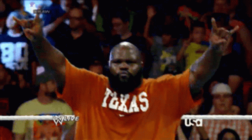 Man in Orange Shirt Saying Texas Peace Sign