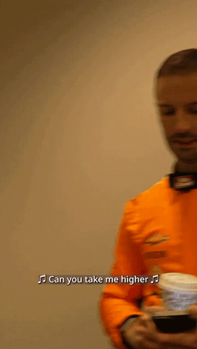 Man In Orange Shirt Singing Can You Take Me Higher GIF