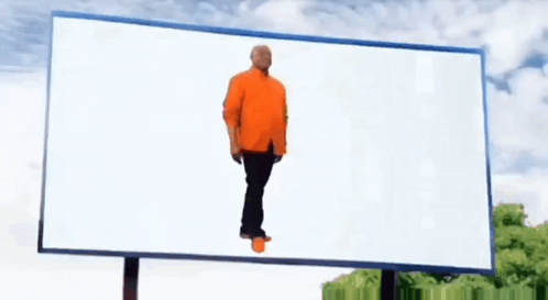 Man in Orange Shirt Standing by White Billboard