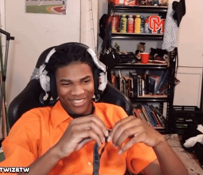 Man in Orange Shirt With Twizbtw Sticker