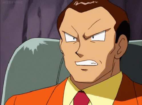 Man in Orange Suit and Red Tie Sitting Angry