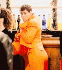 Man In Orange Suit Dancing GIF