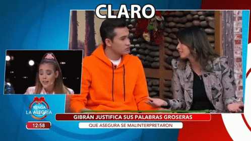 Man in Orange Sweatshirt Talking to Woman on TV Claro