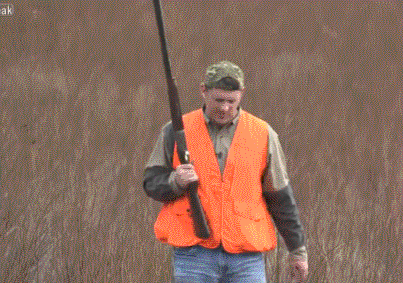 Man in Orange Vest Holding Gun