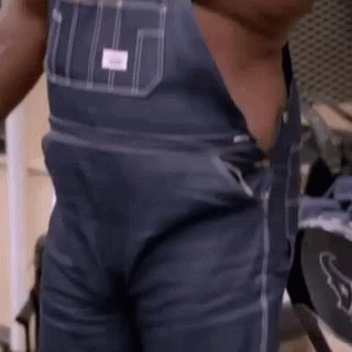 Man in Overalls Standing Shirtless