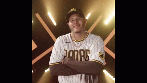 Man in Padres Jersey with Arms Crossed Smiling