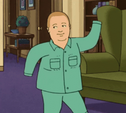 Man in Pajamas Standing Next to Green Chair
