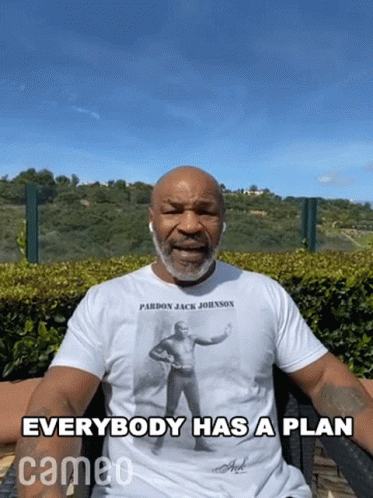 Man In Pardon Jack Johnson T-Shirt Says Everybody Has A Plan GIF