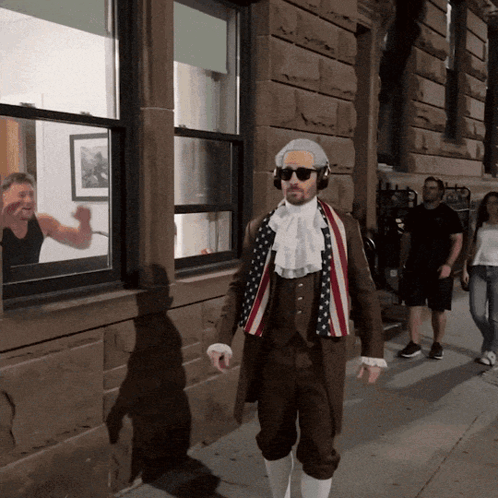 Man In Patriotic Costume Walking Down Sidewalk GIF