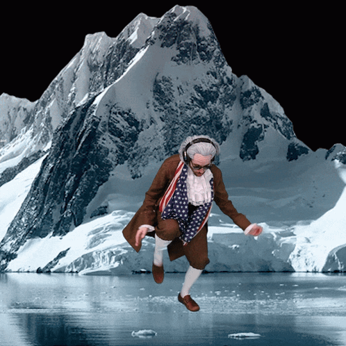 Man In Patriotic Outfit Jumping By Snowy Mountain GIF