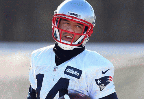 Man in Patriots Jersey and Gillette Helmet Holding Football