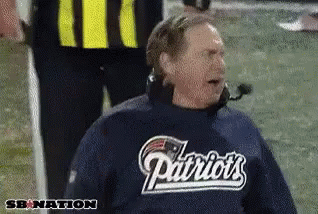 Man in Patriots Shirt Sitting on Field