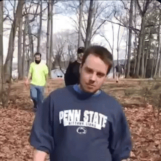 Man In Penn State Shirt Walking Through Forest GIF