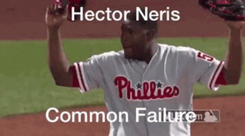 Man in Phillies Jersey Holding Glove Over Head