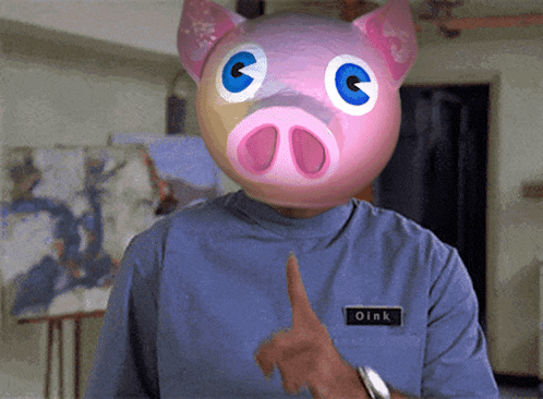 Man in Pig Mask with Oink Name Tag Thumbs Up