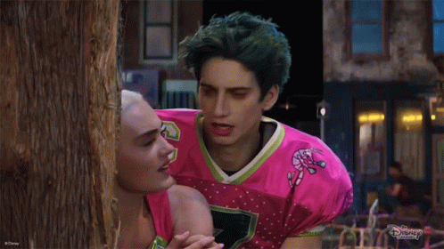 Man in Pink Candy Cane Jersey With Woman