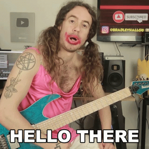 Man in Pink Dress Holding Guitar Hello There