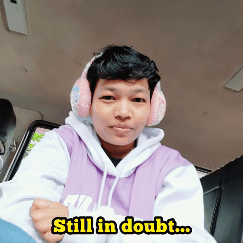 Man in Pink Ear Muffs and Purple Nike Hoodie