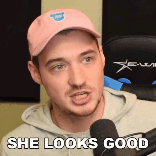 Man In Pink Hat And Hoodie Says She Looks Good GIF
