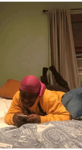 Man in Pink Headband Lying on Bed