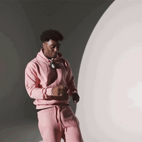 Man In Pink Hoodie And Pink Sweatpants Near White Sphere GIF
