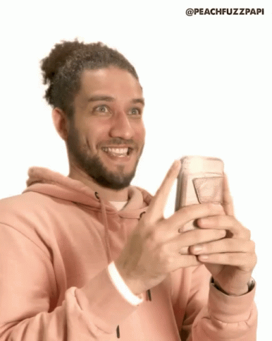 Man in Pink Hoodie Holding Cell Phone