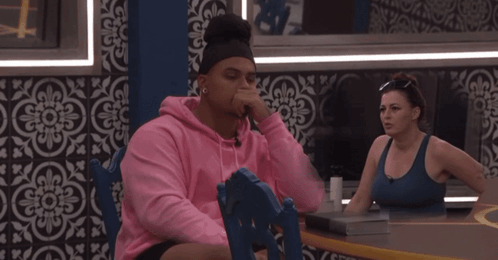 Man In Pink Hoodie Sitting At Table GIF