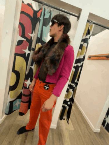 Man in Pink Jacket and Orange Pants in Changing Room