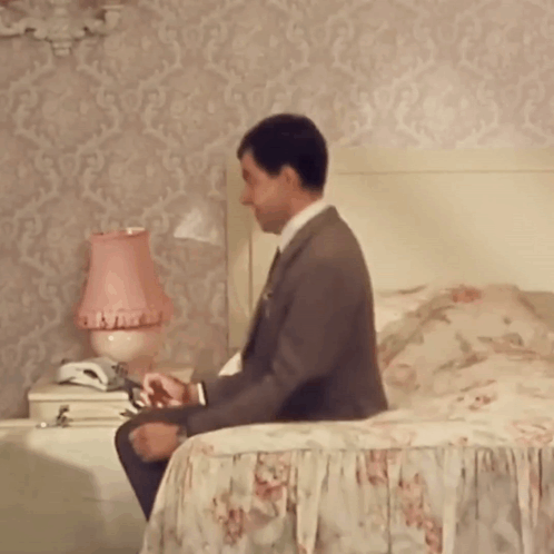 Man In Pink Jacket At Orange Door GIF