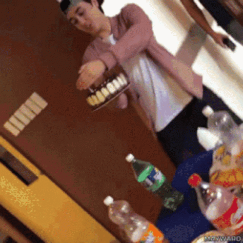 Man in Pink Jacket Holding Coca Cola Cake