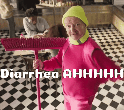 Man in Pink Outfit Holding Broom Saying Diarrhea Ahhhh