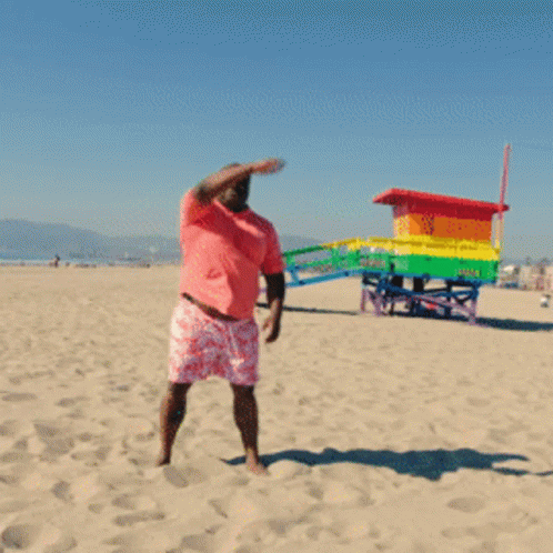 Man in Pink Shirt and Shorts on Beach