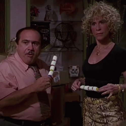 Man in Pink Shirt and Tie Next to Blonde Woman