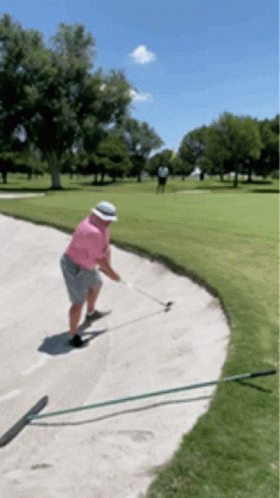 Man In Pink Shirt And White Hat Swinging Golf Club GIF
