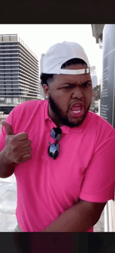 Man in Pink Shirt and White Hat Thumbs Up