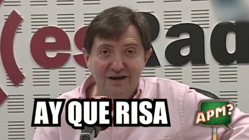 Man in Pink Shirt Ay Que Risa Sign