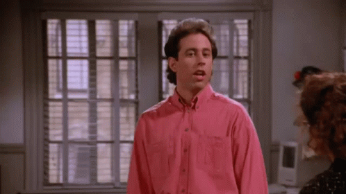 Man in Pink Shirt by Window With Blinds