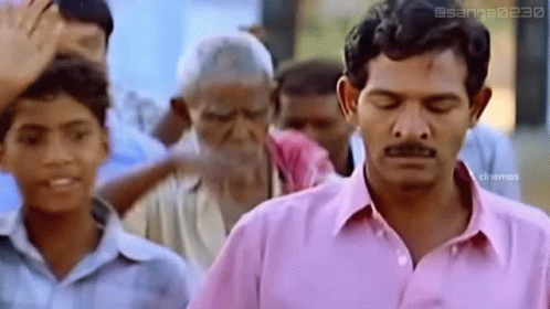 Man In Pink Shirt Eyes Closed In Front Of Crowd GIF