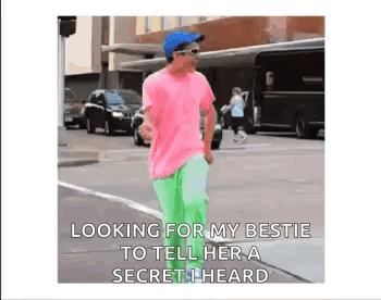 Man In Pink Shirt Green Pants Telling Secret GIF