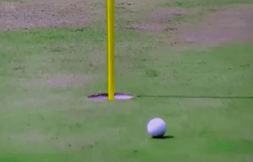 Man in Pink Shirt Holding Golf Ball