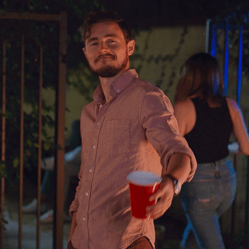 Man In Pink Shirt Holding Red Cup GIF