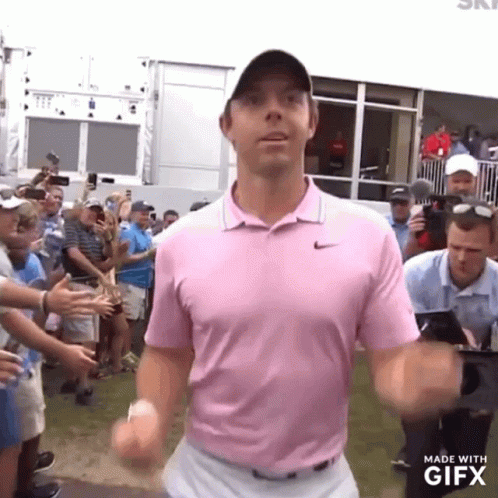 Man In Pink Shirt In Front Of Crowd GIF