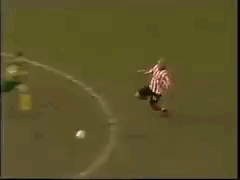 Man in Pink Shirt Lying Before Goalie
