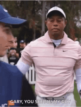 Man in Pink Shirt Next to Another Man on Golf Course